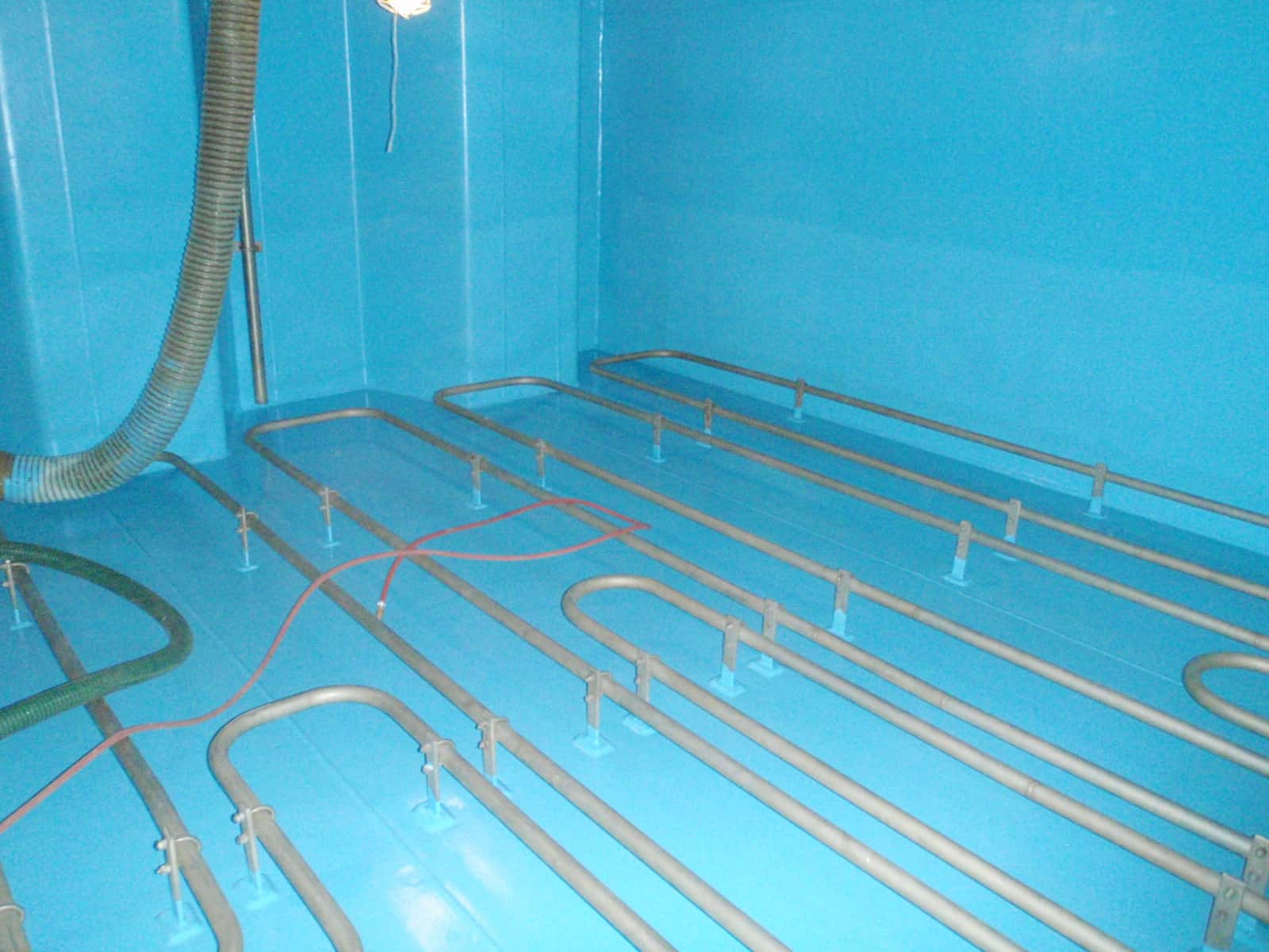 Completed Application blue chemical tank walls and floor with metal piping