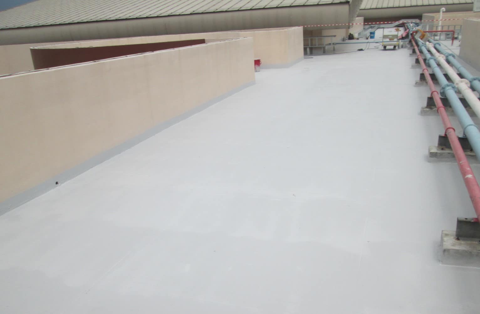 school roof painted in white with small coloured pipes