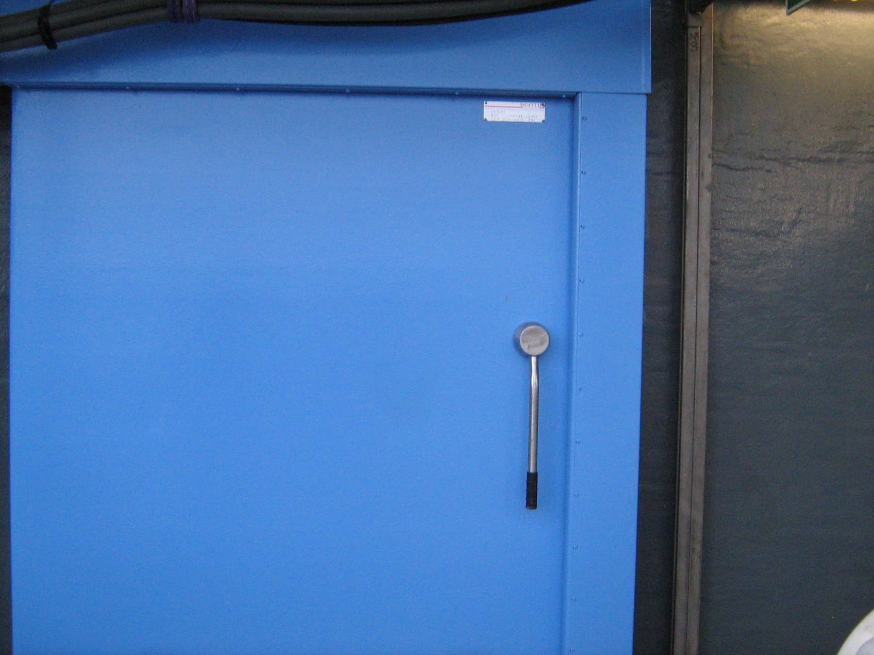 external door on offshore platform painted in blue