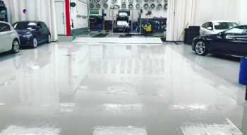 glossy white painted floor in car showroom