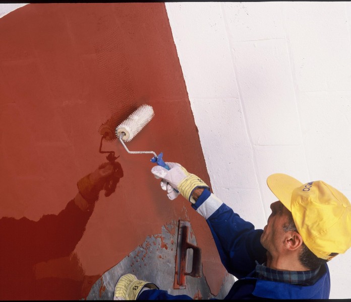 application of red paint to vessel flooring