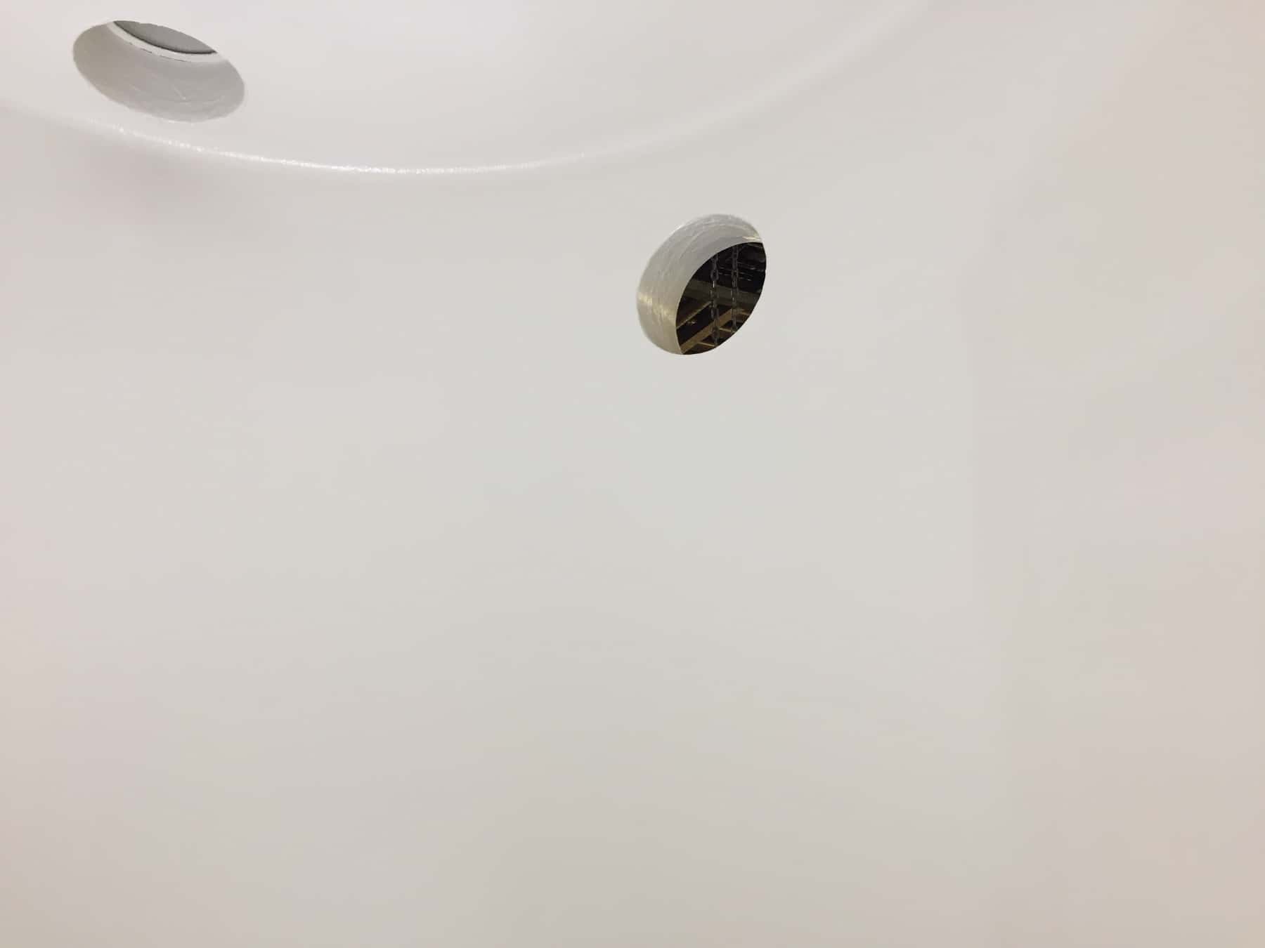 stainless steel tank wall painted in white with round hole