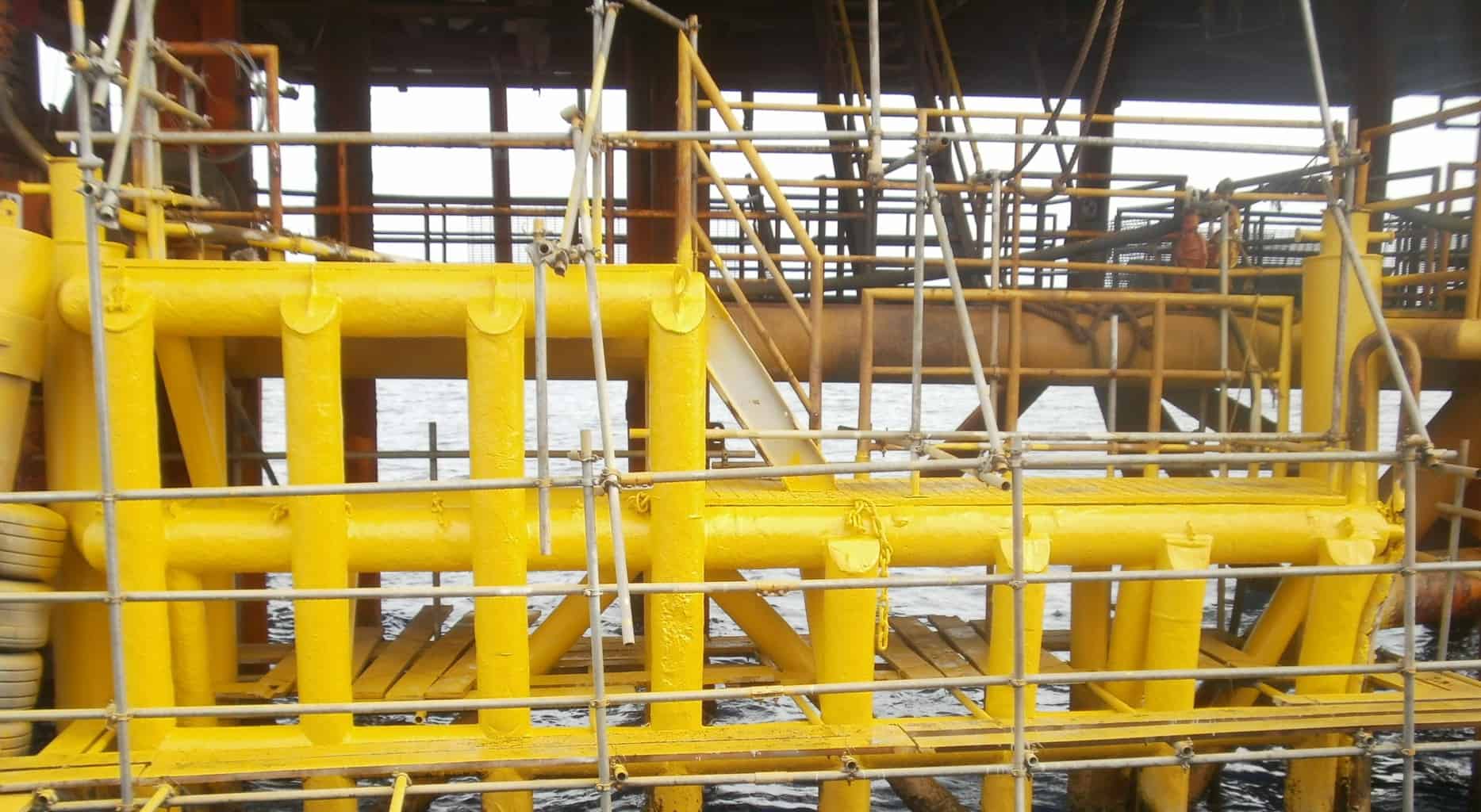 yellow offshore pipes and scaffolding