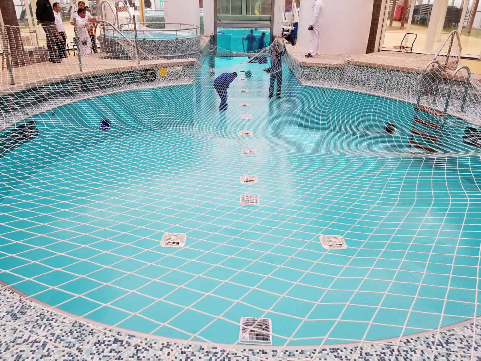 ship swimming pool painted in blue with protective netting