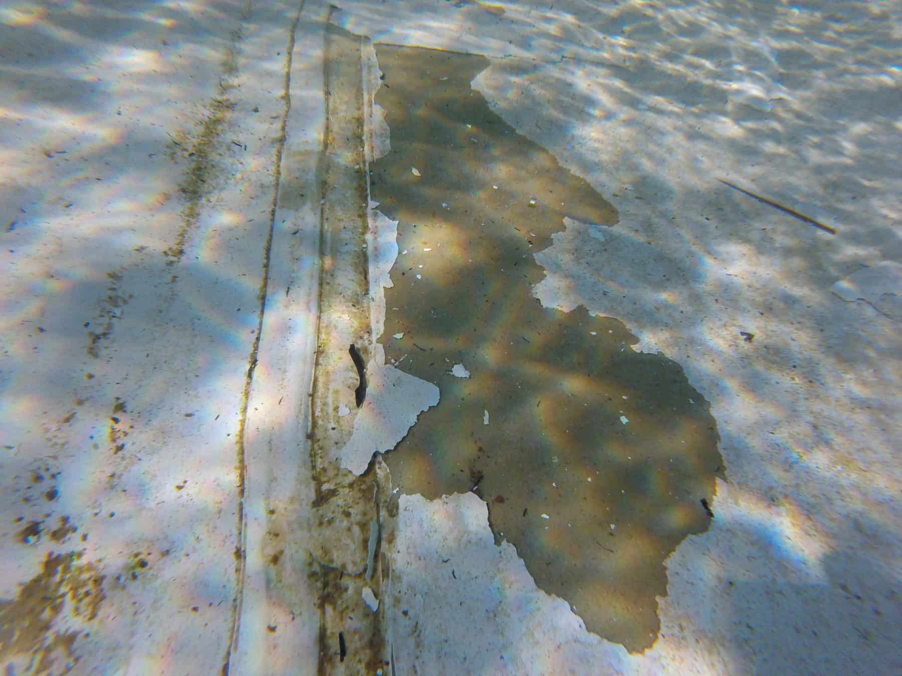 old failed coating peeling from underwater substrate
